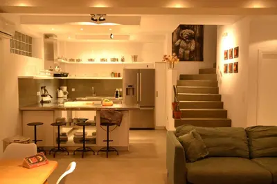 a living room with a couch and a kitchen at Kokinogremos Villa in Kalithies