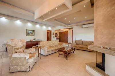 a large living room with couches and a fireplace at Villa Rose in Kolimbia