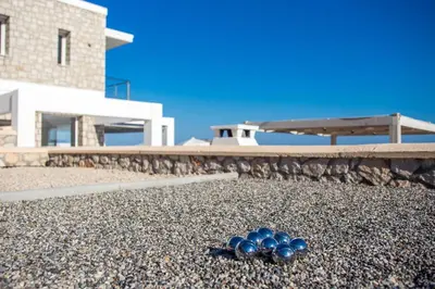 a group of blue balls sitting on a pile of gravel at Sea view villa with private pool Horizontes in Kalithies