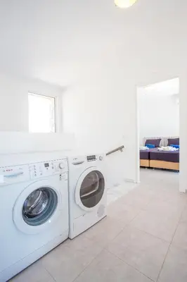 a white washer and dryer in a white room at Sea view villa with private pool Horizontes in Kalithies