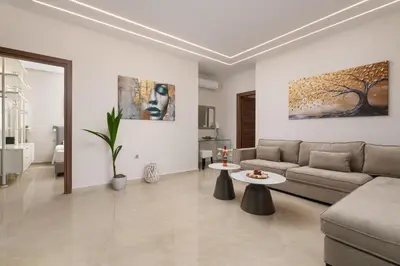 a living room with a couch and a table at Aelia Luxury Apartment-with swimming pool in Afantou