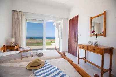 a bedroom with a bed and a mirror and a window at Kamiros Apartment in Kalavárda