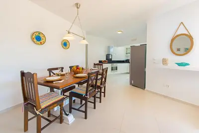 a kitchen and dining room with a table and chairs at Villa Giovanni in Faliraki
