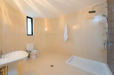 a white bathroom with a sink and a toilet at Villa Giovanni in Faliraki