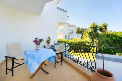 a patio with a table and chairs on a balcony at Villa Giovanni in Faliraki