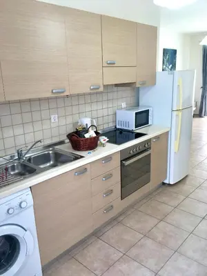 a kitchen with a sink and a refrigerator at Harmonia at Gennadi Court in Gennadi