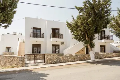 a white building with a tree in front of it at Harmonia at Gennadi Court in Gennadi