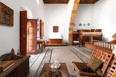 a living room with a couch and a table at Antique Villa in Líndos