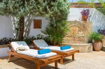 two lounge chairs with towels on top of them at Antique Villa in Líndos