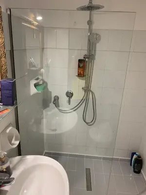 a shower in a bathroom with a sink at Alkyonides Boutique Hotel in Kremasti