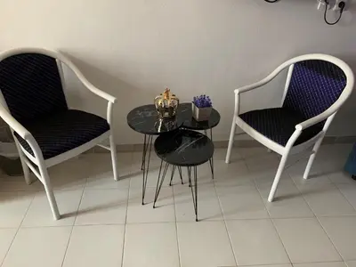 two chairs and a table in a room with a table and chairs at Alkyonides Boutique Hotel in Kremasti