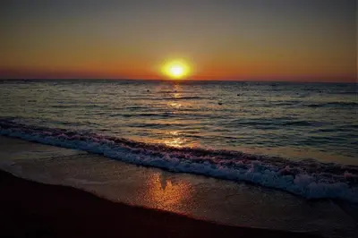 a sunset on the beach with the ocean at Alkyonides Boutique Hotel in Kremasti