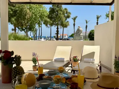 a table with food and chairs on a patio at Steve's Beach in Faliraki