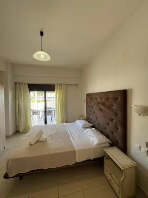 a bedroom with a large bed with a large headboard at Steve's Beach in Faliraki