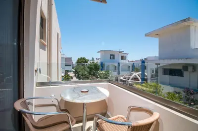 a balcony with a table and two chairs and a view at Steve's Beach in Faliraki