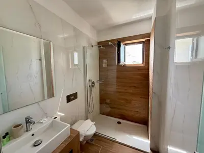 a bathroom with a shower and a sink and a toilet at Steve's Beach in Faliraki