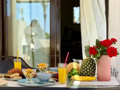 a table with food and drinks and a pineapple on it at Steve's Beach in Faliraki