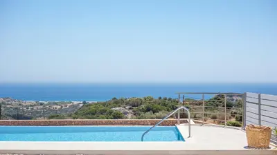 a swimming pool with a view of the ocean at Francis & Gregorys Luxury Villas in Afantou