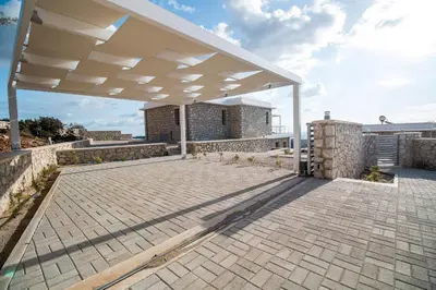a pavilion with a roof on top of a building at Francis & Gregorys Luxury Villas in Afantou