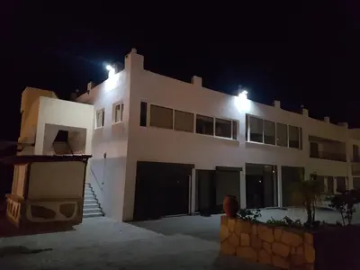 a white house with lights on top of it at night at Courtyard Studios in Pefki Rhodes