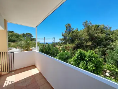 a balcony with a view of trees and bushes at Courtyard Studios in Pefki Rhodes