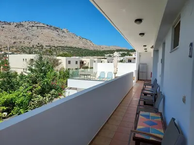a balcony with chairs and a view of a mountain at Courtyard Studios in Pefki Rhodes