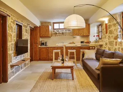 a living room with a couch and a table at Helios Garden Boutique Apartments in Rhodes Town