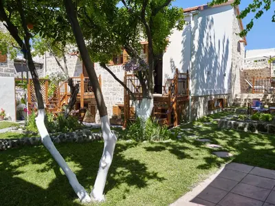 a tree in the middle of a garden at Helios Garden Boutique Apartments in Rhodes Town