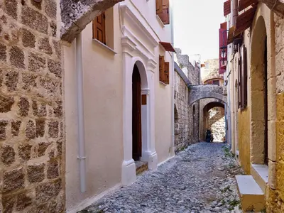 an alleyway between two buildings in a city at Helios Garden Boutique Apartments in Rhodes Town