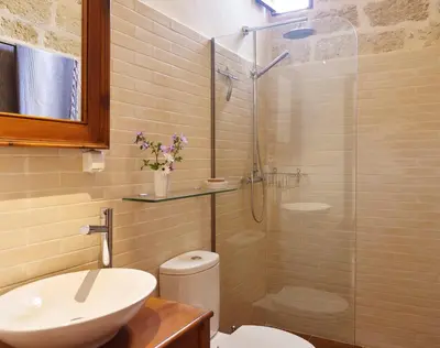 a bathroom with a shower and a toilet and a sink at Helios Garden Boutique Apartments in Rhodes Town