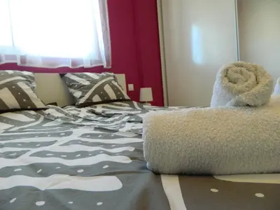 a bed with a teddy bear sitting on top of it at Kalithies apartment in Kalithies