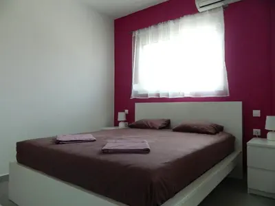 a bedroom with a large bed with a window at Kalithies apartment in Kalithies