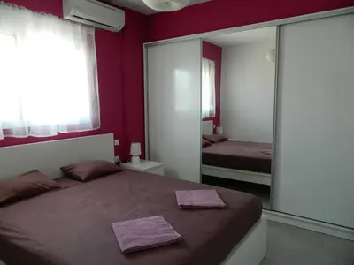 a bedroom with a bed and a large mirror at Kalithies apartment in Kalithies
