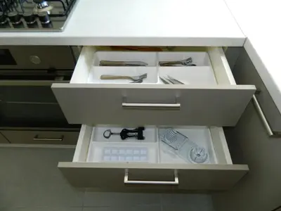 a kitchen with a drawer with knives and scissors at Kalithies apartment in Kalithies
