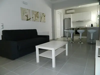 a living room with a couch and a table at Kalithies apartment in Kalithies