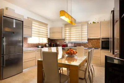 a kitchen with a table with a bowl of fruit on it at Antigone Estate in Koskinou