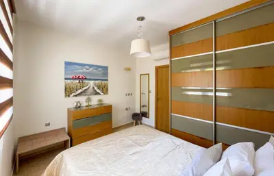 a bedroom with a bed and a wooden headboard at Antigone Estate in Koskinou