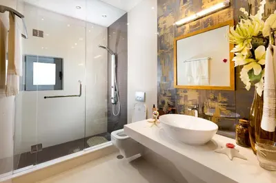 a bathroom with a sink and a shower and a toilet at Antigone Estate in Koskinou