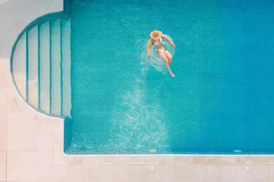 a woman in a swimming pool in the water at Bello Blu Luxury Villa in Asgourou
