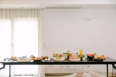 a table with many plates of food on it at Bello Blu Luxury Villa in Asgourou