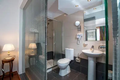 a bathroom with a toilet and a sink and a shower at Danezis City Stars Boutique Aparthotel in Rhodes Town