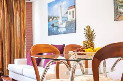 a glass table with a bowl of fruit on it at Danezis City Stars Boutique Aparthotel in Rhodes Town