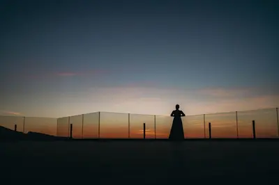 a man standing on a rooftop looking at the sunset at Sheraton Rhodes Resort in Ixia
