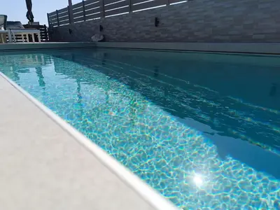 a swimming pool with a blue pool at Villa Fay in Lardos