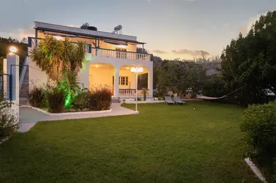 a house with a lawn in front of it at Villa Stegna in Archangelos