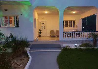 a house with a porch and a bed in the background at Villa Stegna in Archangelos