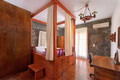 a bedroom with a bed and a desk in a room at Villa Zoi in Gennadi