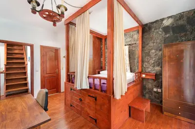 a bedroom with a wooden dresser in a room at Villa Zoi in Gennadi