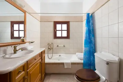 a bathroom with a tub and a toilet and a sink at Villa Zoi in Gennadi