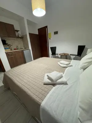 a bedroom with a bed with two towels on it at Fedra Apartments Lindos in Líndos
